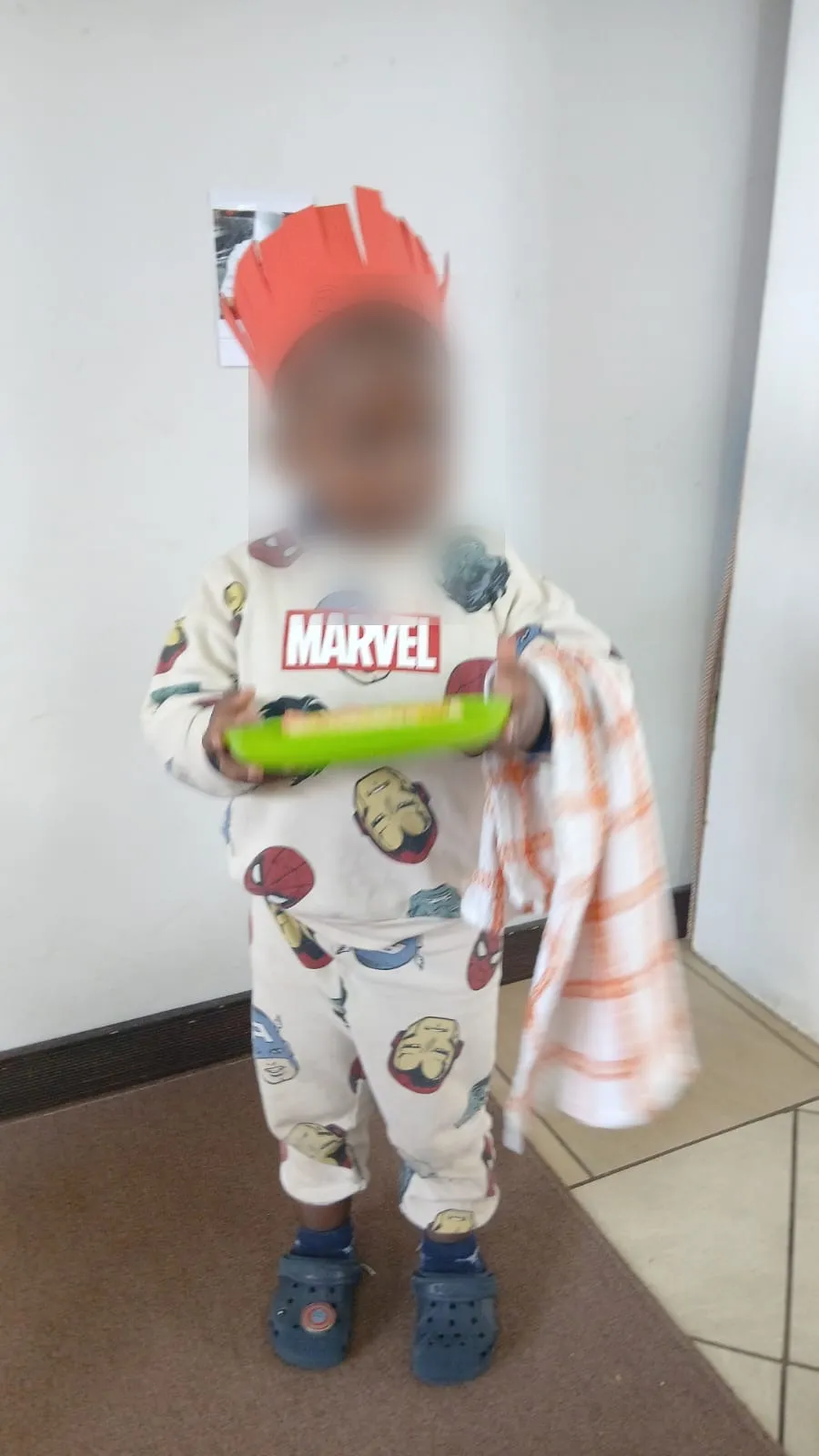 A little chef with a dish towel over his arm, serving his snack